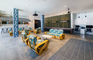 A bright lounge with lounge seating and computer work stations