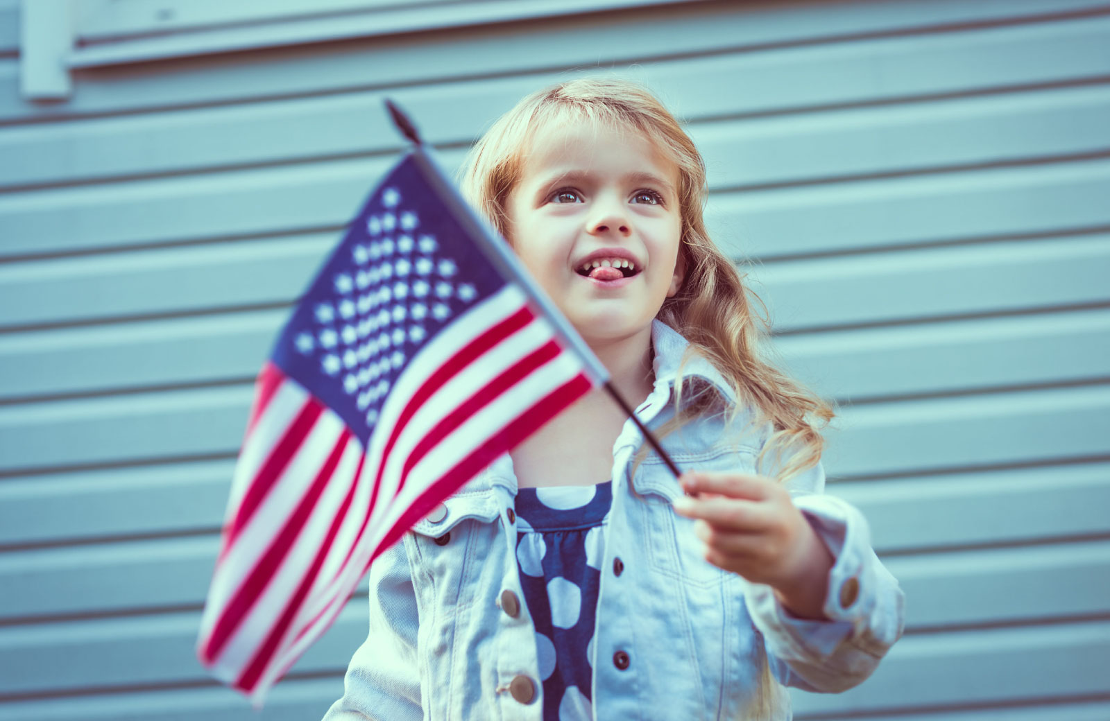 girl waving american flag