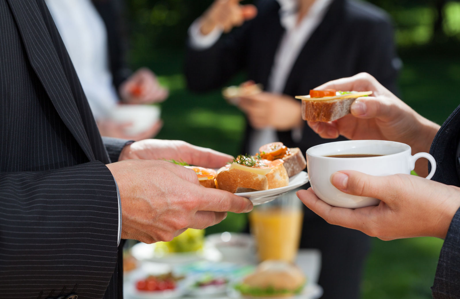 people eating bread and cheese at a party