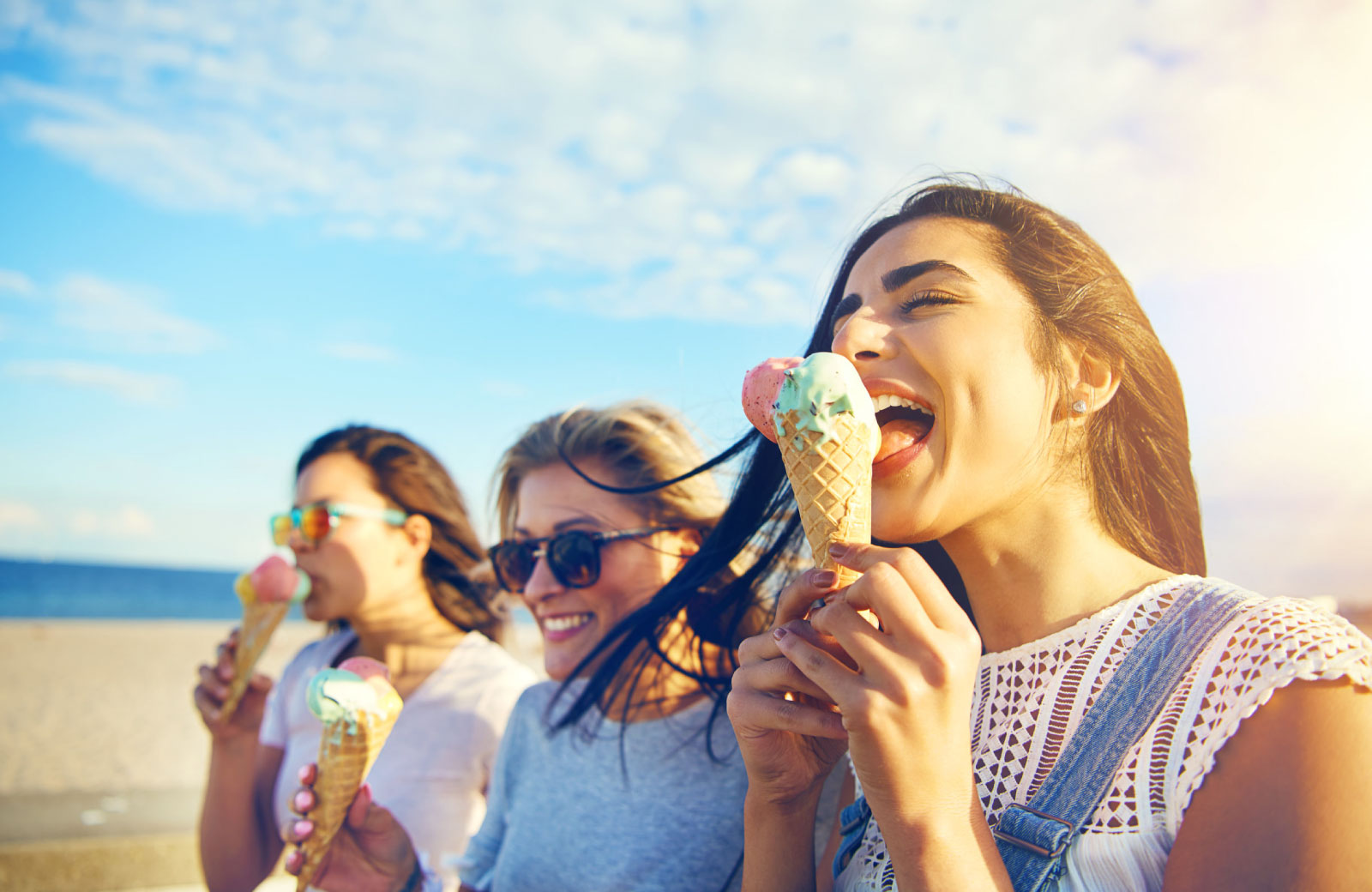 girls eating ice cream on the beach