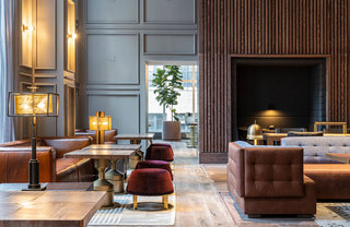 Several conversation sets and table seating arrangements in a large resident lounge.