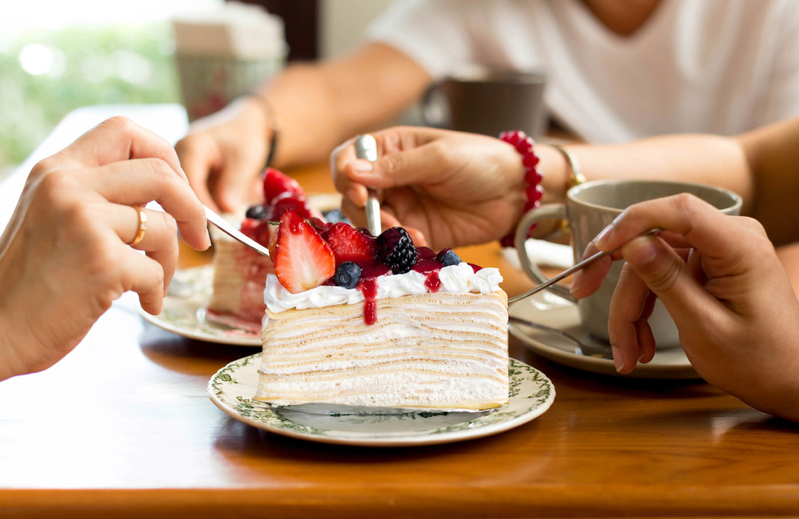 people sharing a slice of cake