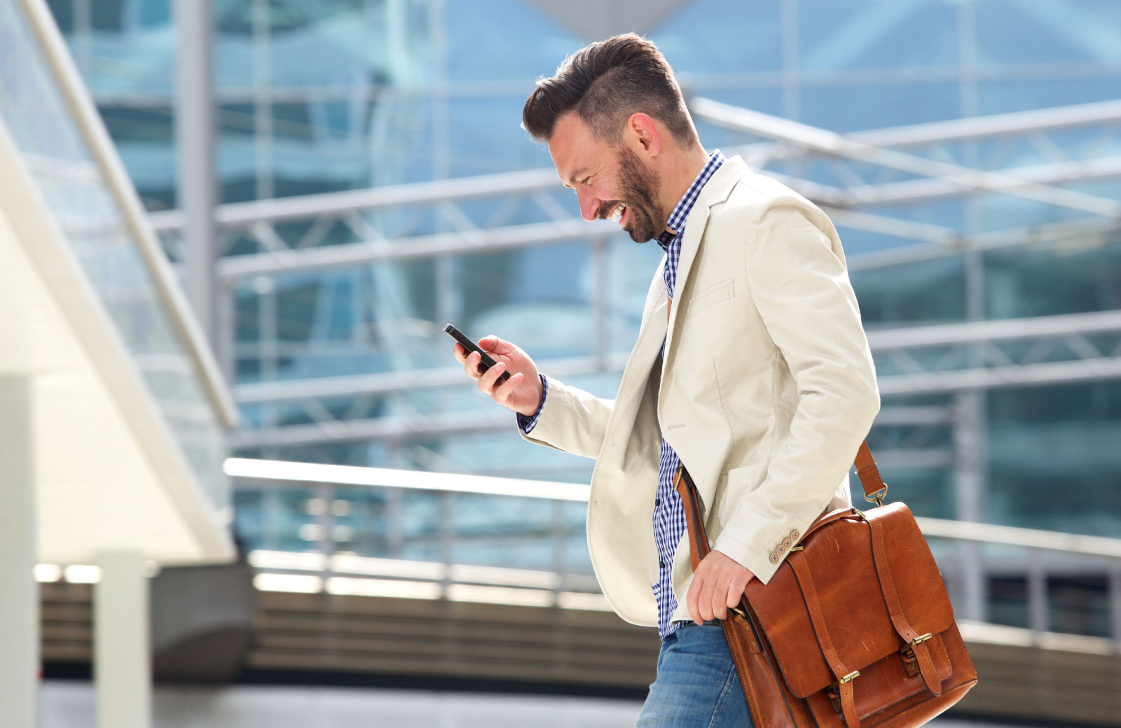 man in business attire looking at his phone