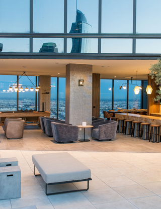 A billiards table, seating, and demonstration kitchen in the Atelier clubroom