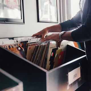 A person thumbing through the selection at a vinyl record store