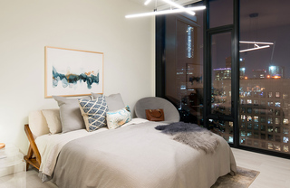 Atelier Penthouse bedroom with king-size bed and views of LA at night