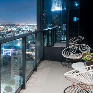Atelier Penthouse balcony with two chairs overlooks LA lights at night