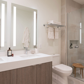 Atelier Penthouse bathroom with double vanity, toilet, and shower
